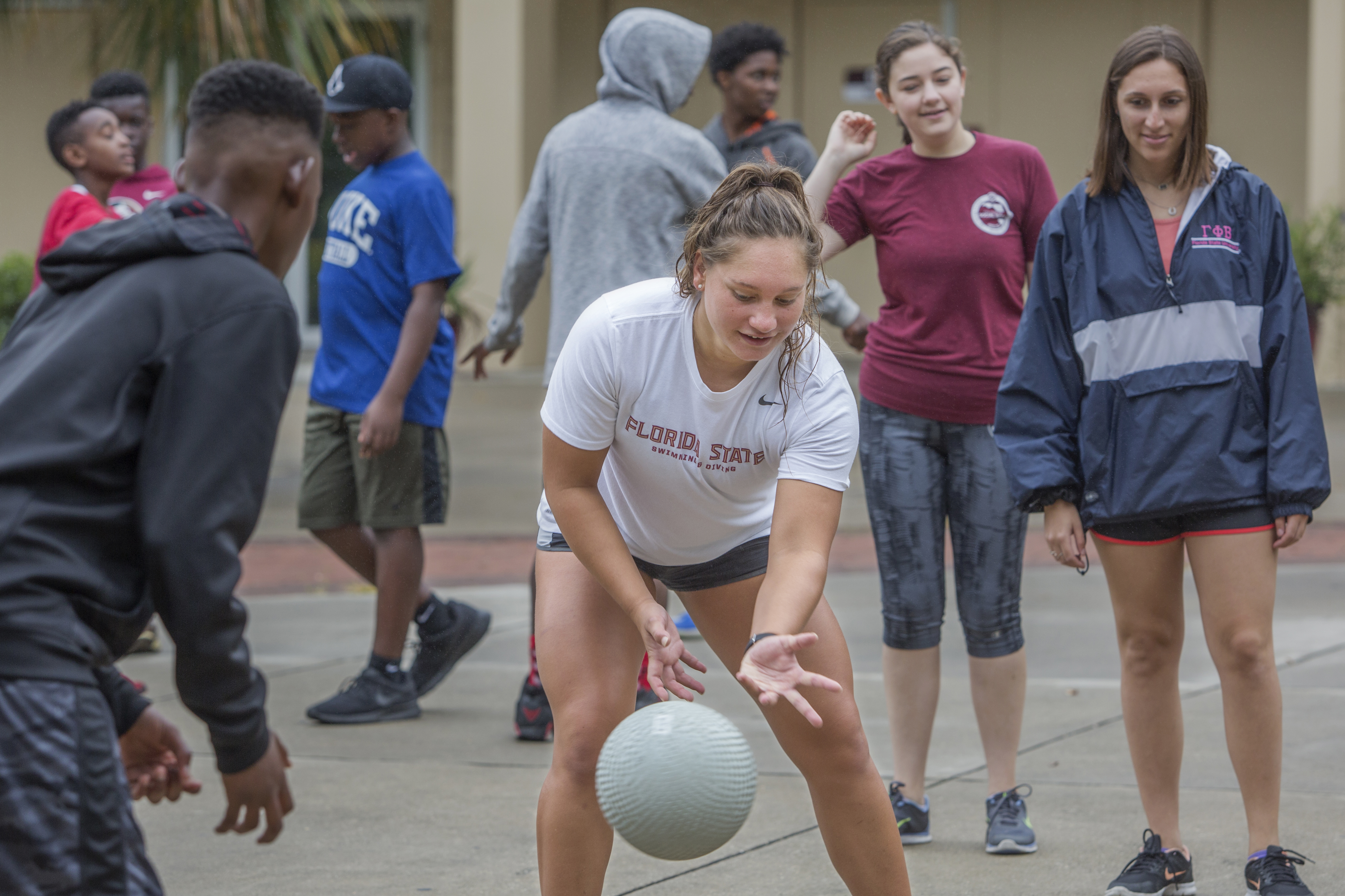 FSU Swimmer Paige Schendelaar-Kimp playing four square with campers.