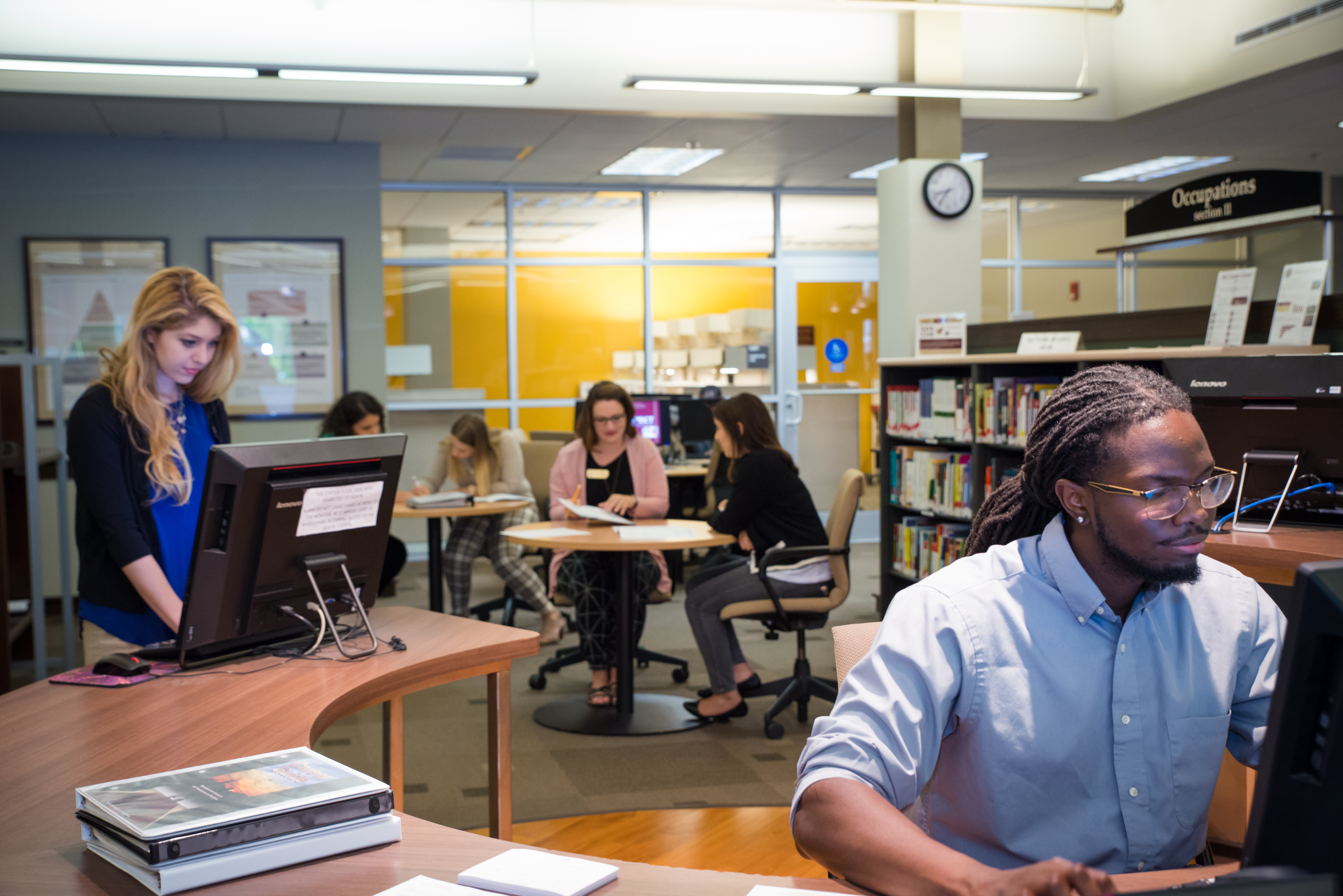 "Photo of FSU Career Center space with students and alumni working at desks and computers"
