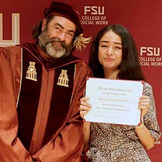 "Dr. Stephen Tripodi posing with Beren Crim Sabuncu recipient of the Dianne F. Harrison Doctoral Scholarship posing with her certificate."