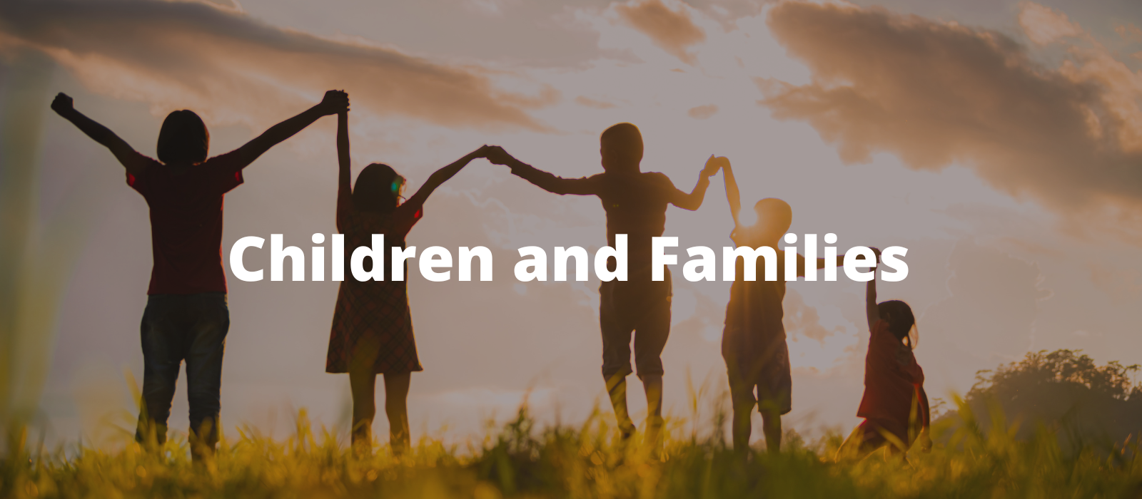 "Silhouettes of five children holding hands and raising their arms against a sunset sky with dramatic clouds with the words Children and Families overlaid."
