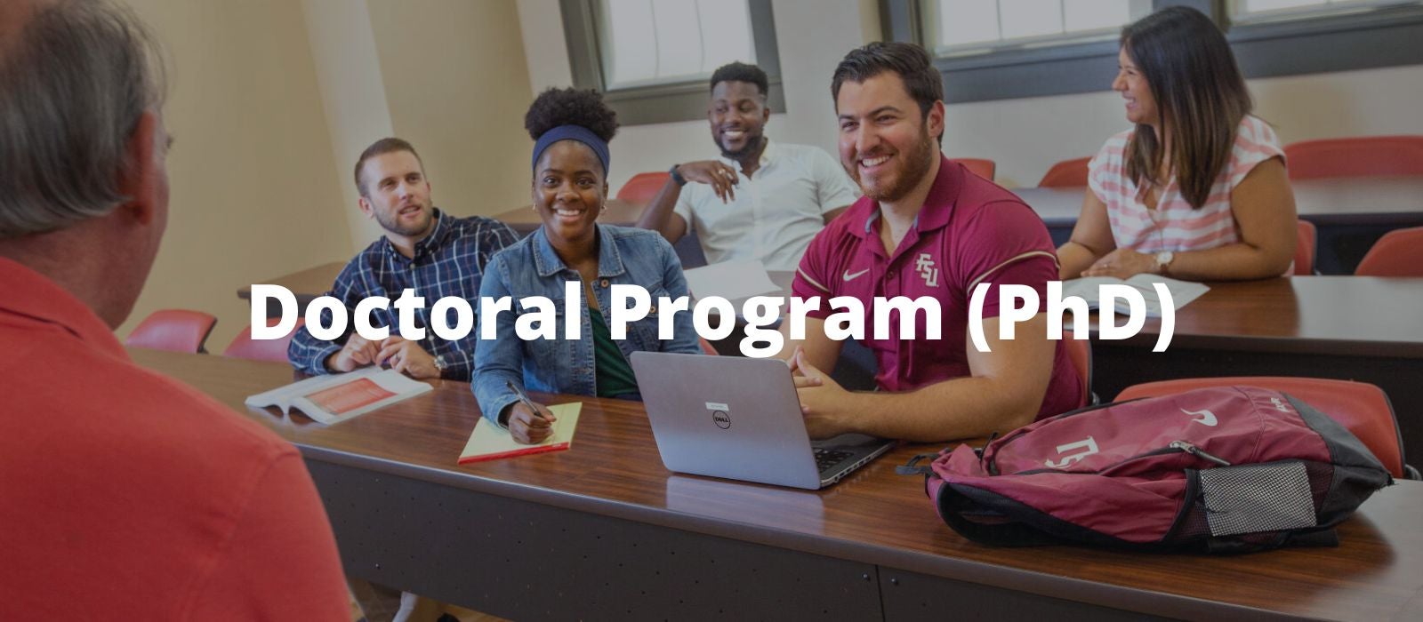 "FSU students in a classrom talkingi with a professor"