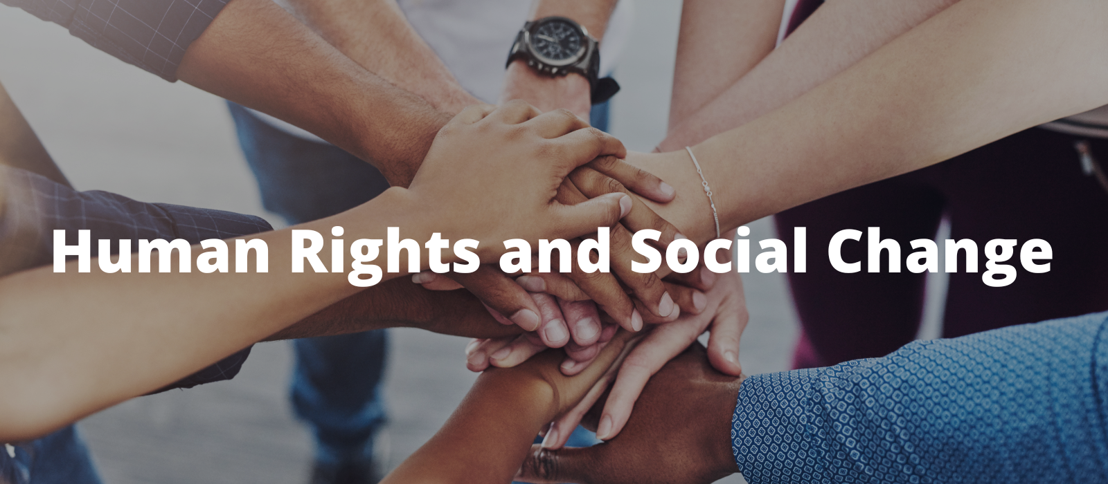 "A close-up shot of several hands stacked on top of each other, symbolizing teamwork and unity."