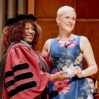"Dr. Carol Edwards posing with BSW Student of the Year Audrey Rose holding her octagonal crystal award."