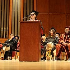 """Keynote Speaker Bolivar Aguirre speaking at the podium at the Spring 2026 graduation event."""