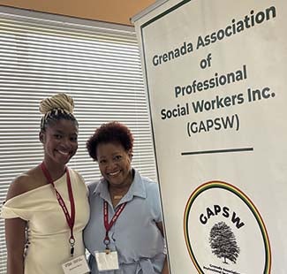 "Beatrice Réne and Dr. Carol Edwards posing with the Grenada Association of Professional Social Works, Inc. sign"