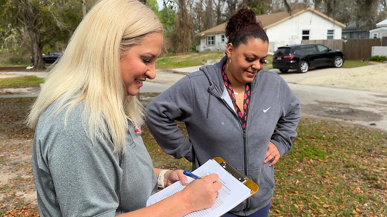"Sunshine Arnold, left, as a licensed clinical social worker. It's a job that goes beyond making desk calls. Photo by: Spectrum Bay News 9/Calvin Lewis"