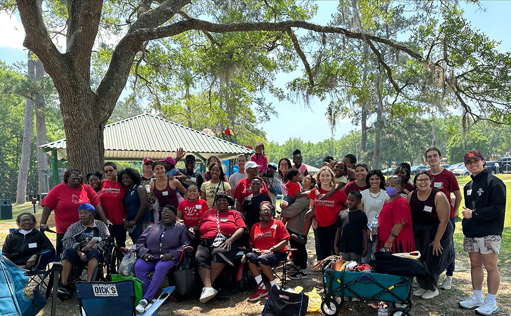 "ErikaCuffy with FSU social work students collaborating with the Tallahassee Senior Center's Grandparents as Parents program to host a picnic event for grandparents and their grandchildren."