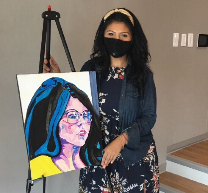 "Juanita Martinez with the portait done of her by artist, Iliana Van Pelt"