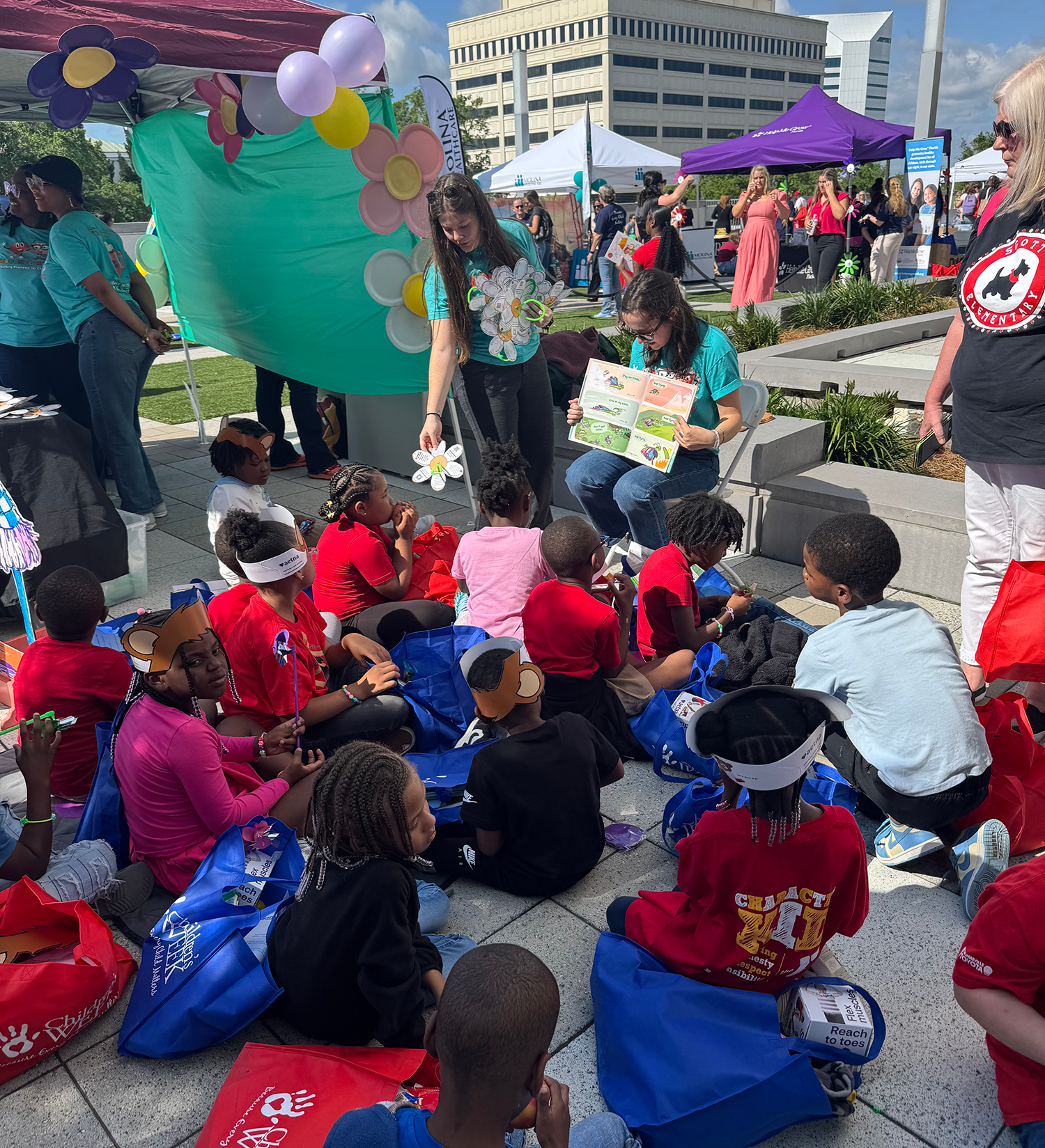 "Children visiting the Rebound & Recovery booth at the Storybook Village"