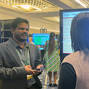 "Doctoral Sanoop Valappanandi presenting a research poster."