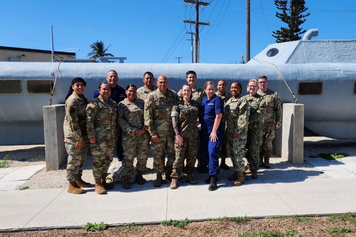 "Female senior enlisted leaders of JIATF-S pose in front of ‘Bigfoot,’ a semisubmersible drug vessel seized by the unit."