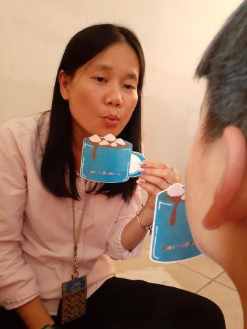 ELC Behavior Specialist teaching a child how to do "Hot Cocoa Breathing"