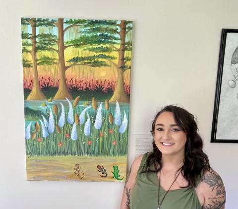 Ariana with her painting "Psychedelic Newts (For Aaron)”