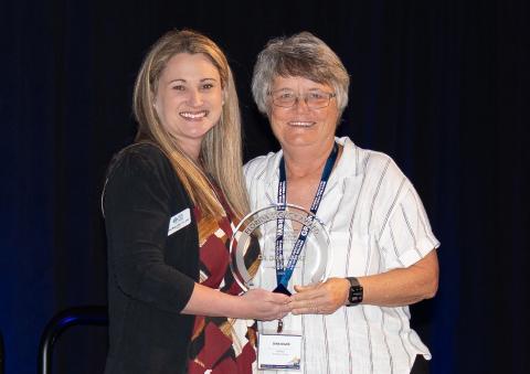 Lisa Magruder and Dina Wilke posing with Dina's Legacy Award. 
