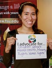 Student holding up a sign about what they support