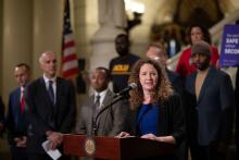IJRD Founding Executive Director Carrie Pettus speaks at a news conference in Pennsylvania about re-entry initiatives. At far left is Pennsylvania Gov. Tom Wolf.