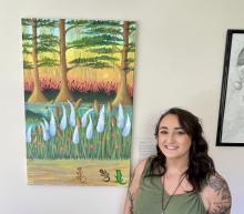 Ariana with her painting "Psychedelic Newts (For Aaron)”