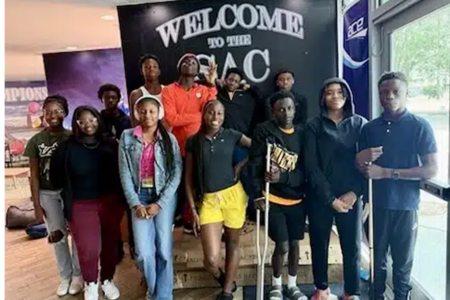 "Students participating in the Student ACES program posing in front of a Welcome to the SAC sign.""Students participating in the Student ACES program posing in front of a Welcome to the SAC sign."