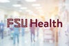 FSU Health logo in garnet overlaid on a colorful picture of a busy hospital corridor with people in scrubs walking around.