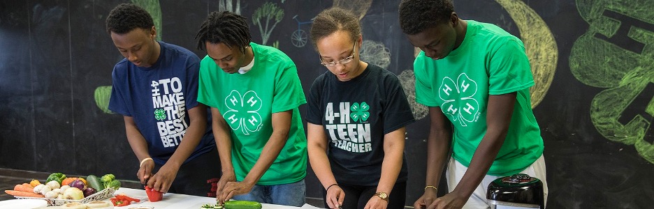 "4H-Program image of four Black teens preparing a healthy meal."