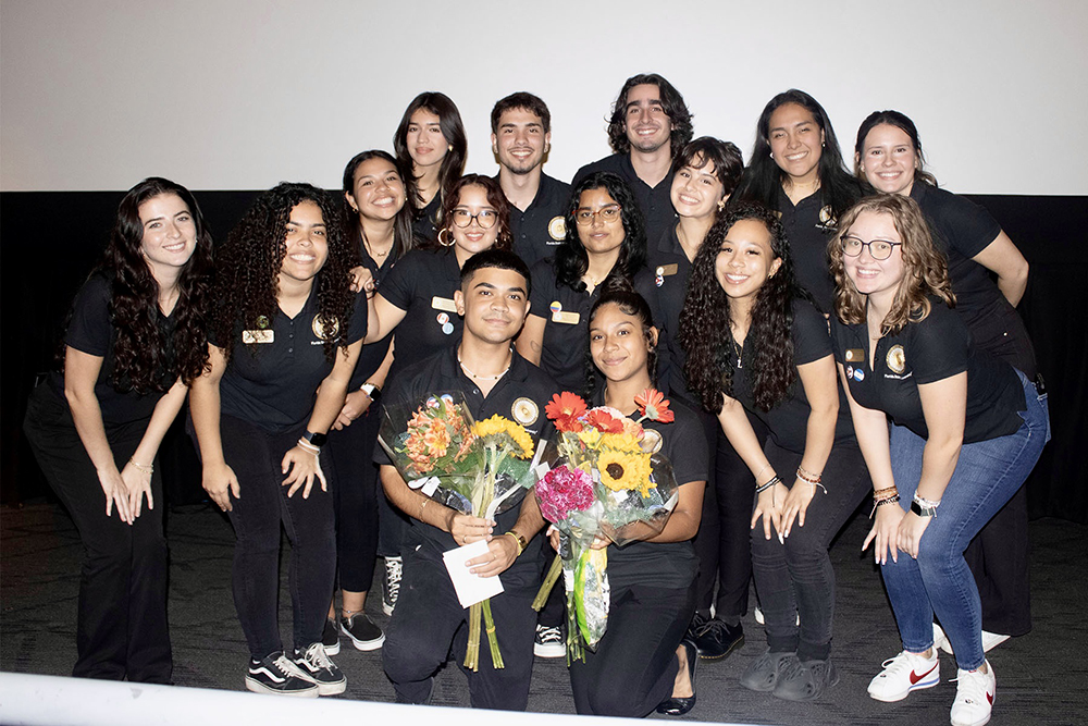 "Maximo Valdes and Nicole Alvarado (L to R with flowers) and Javier Puebla (back row second from L) use their roles on the executive board of the Hispanic/Latinx Student Union to help others find the same welcoming community they have found at FSU. (Hispanic/Latinx Student Union)"