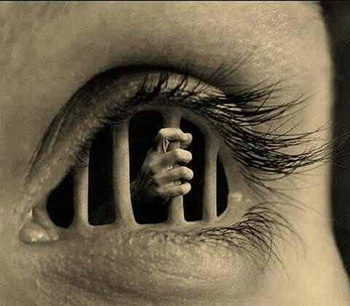 "AI- generated image of a person's eye altered to have prison bars within the shape of the eye and a hand gripping the bars""