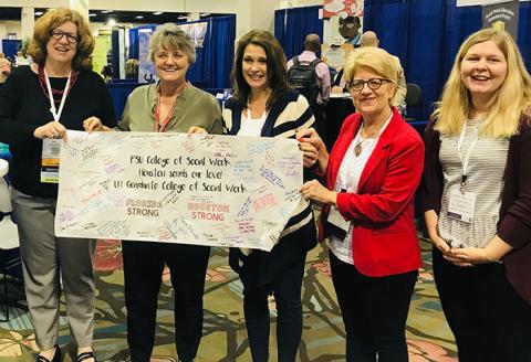 University of Houston team presents the banner to FSU at CSWE.