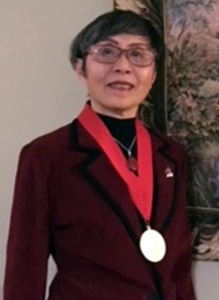 Amy L Ai wearing her American Academy of Social Work and Social Welfare medal