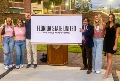 Olivia Pruit, Sydney Carrow, Jeff Binkley, Provost Jim Clark, Brenna Hopper, Kendall holding a sign that reads Florida State United One Voice Against Hate