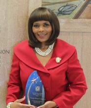 Terriyln Rivers-Cannon posing with her School Social Worker of the Year Award.