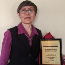 Dr. Amy Ai pictured with her innovation Award plaque from the International Society for Traumatic Stress Studies