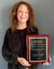 Carrie Pettus with her 2022 Social Policy Researcher Award from the Society for Social Work and Research